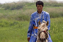 A Mongolian horseman rides within the ruined walls of Xanadu (also known as ShangDu) where Kublai Khan, leader of the Mongolian empire, had his summer capital. Inner Mongolia, northern China. July 200...