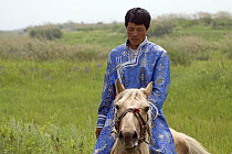 A Mongolian horseman rides within the ruined walls of Xanadu (also known as ShangDu) where Kublai Khan, leader of the Mongolian empire, had his summer capital. Inner Mongolia, northern China. July 200...