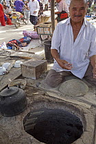 A man in Hotan City making bread in a muslim part of Xinjiang Province, north-west China. July 2006