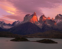 The peaks of the Torres del Paine, above Lake Pehoe, lit by the sunrise at Torres del Paine National Park, Chile