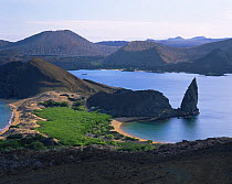 A view across Bartolome Island and Pinnacle Rock, with Santiago Island in the background, Galapagos
