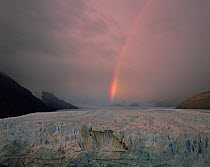 A rainbow forms as a storm passes over Moreno Glacier, Glaciers National Park, Argentina