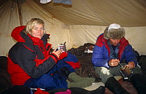 Martha Holmes and Doug Allan eating in tent while filming on location in Canadian Arctic for BBC NHU Blue Planet, May 1998