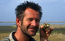 Nigel Marven, Producer / Presenter, holding a male marsh frog vocalising, Anzali, Iran