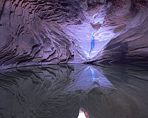 A small waterfall is reflected in a pool at in North Canyon, Grand Canyon National Park, Arizona