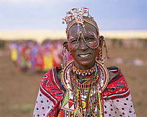 Masai woman villager wearing traditional beads and clothes. Masai Mara National Reserve, Kenya
