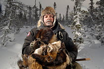 Trapper with his catch of one wolverine and four pine martens through the taiga of Manitoba, at -45 degrees C, Canada.