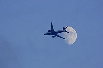 British Airways plane flying in front of the moon, UK