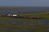 Aerial view of part of Prudhoe Bay's industrial oil fields and sprawling development, along the coast of the Beaufort Sea, Alaska