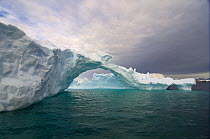 Arched iceberg floating off the western Antarctic peninsula, Southern Ocean