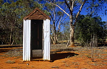 Outback 'dunny' (toilet) with bullet holes, Bourke, New South Wales, Australia