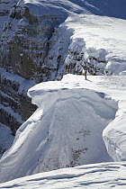 Skier views giant cornices on Brooks Mountain, Bridger-Teton National Forest, Wyoming, USA