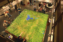 People looking at a 3-dimensional map of Yellowstone Park, Canyon Vistor and Education Center, Canyon Village, Yellowstone National Park, Wyoming, USA