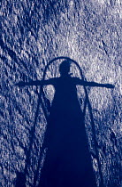 Shadow in the water of a person with their arms outstretched at the bow of SY "Adele", 2006.