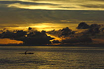 Silhouette of a canoeist at sunset, French Polynesia, 2006.