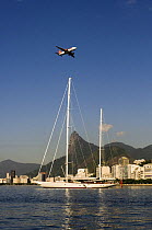 Plane flying over SY "Adele", 180 foot Hoek Design, anchored in Enseada de Botafogo, Rio de Janeiro, February 2007  Non editorial uses must be cleared individually.