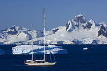 SY ^Adele^, 180 foot Hoek Design, motoring past icebergs at Portal Point, Reclus Peninsula, Antarctica, January 2007 Non editorial uses must be cleared individually.