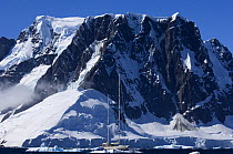 SY "Adele", 180 foot Hoek Design, dwarfed by dramatic mountains as she motors in the Lemaire Channel, Antarctica, January 2007 Non editorial uses must be cleared individually.
