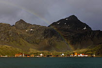 A rainbow arcs over the old whaling station of Grytviken in King Edward Cove, South Georgia, February 2007.