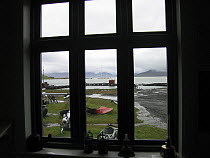 Looking out of the window of Grytviken Museum, which was established in 1992, at SY "Adele" anchored at King Edward Point, South Georgia, February 2007.