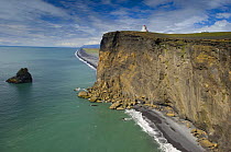 Lighthouse on high steep cliffs near Vik, South Iceland