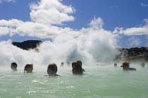 Bathers relaxing in The Blue Lagoon, Thermal area and swimming pools on the Reykjanes Peninsula, near Reykjavik, Iceland