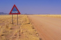 Sign warning of the danger of sand on the road, Namib desert, Namibia