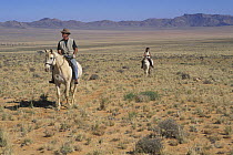 Two people horse riding in the Namib desert, Namibia