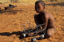Young Bushman San with model car, Bushmanland, Namibia
