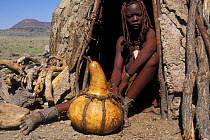 Himba woman at hut entrance, Kaokoland, Namib desert, Namibia