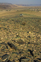 View of Kaokoland with a 4X4 vehicle in the distance, Namib desert, Namibia