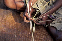 Woman weaving rushes in Sainte Luce fishing village, South East Madagascar