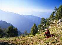 A Hiker resting and admiring the view in Cadi Moixero Natural Park, Spanish Pyrenees