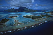 Aerial view of Bora Bora Island, Society Islands, French Polynesia, with fringing reef and lagoon clearly visible. June 2002.