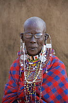 Portrait of an old Masai woman wearing glasses and adorned with bead work, Kenya