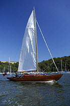 Bermudan Sloop sailing along the River Dart near Dartmouth, Devon.