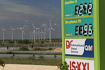 Juxtaposition of petrol filling station and wind farm, Castille, Spain