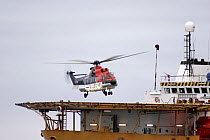 A helicopter lands on the deck of the dive support vessel Seaway Osprey in the North Sea, January 2006