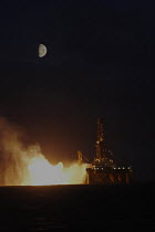 The oil rig J.W McLean flares off gas at night during drilling operations in the North Sea, September 2006
