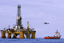 A helicopter and supply vessel next to the oil rig J.W McLean, North Sea, September 2006
