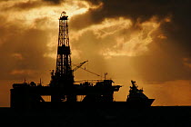 Silhouette of a supply vessel and oil rig in the North Sea, September 2006