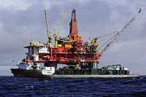 The rock dumping vessel Seahorse covers a subsea pipeline in front of the Statfjord Bravo production platform in the Norwegian section of the North Sea, September 2007