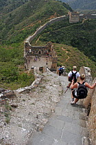 A group of hikers descend steep steps along a section of the Great Wall of China, Hebei Province, September 2007