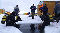 Divers preparing to Ice dive under ice in the White Sea, Northern Russia  March 2008