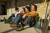 Volunteers take a break from work at the Avon Wildlife Trust Folly Farm Centre, Somerset, UK. Model released