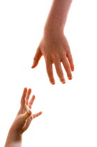 Two children reaching out to grab each other's hands.