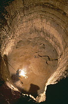 Potholer being lowered down into cave system, Sima del Corral Ciego, Huesca, Spain, September 1992