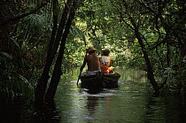 Locals fishing from small boat in flooded Amazon rainforest during rainy season. Rio Tabajos, Brazil 1994
