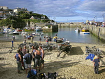 Rowers wait for the next heat on Harbour Beach at the Cornwall County Championships Pilot Gig event, Newquay, Cornwall. September 2007.