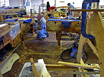 Man at work in Lyme Regis' Boat Building Academy, Dorset, July 2008